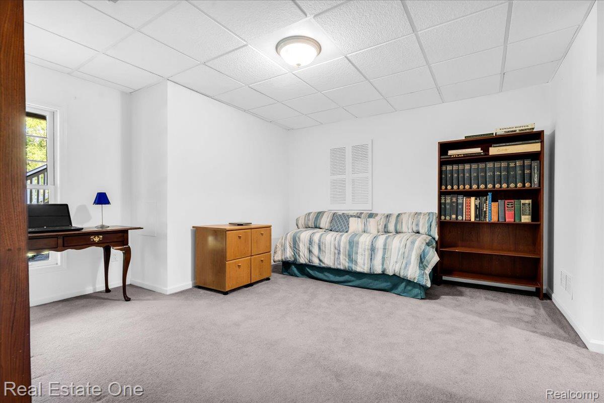 33850 Braebury Ridge Farmington, MI 48331 - Photo 54 of 85 Bright room featuring light gray carpet, white walls, and a drop panel ceiling