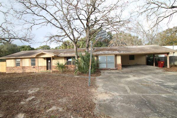 6047 Eden Square Crestview, FL 32539 - Photo 30 of 39 a front view of a house with a garden