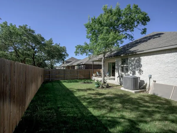 a view of a patio with table and chairs and potted plants