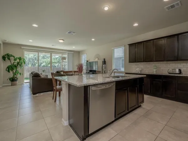 a view of a house with backyard sitting area and garden