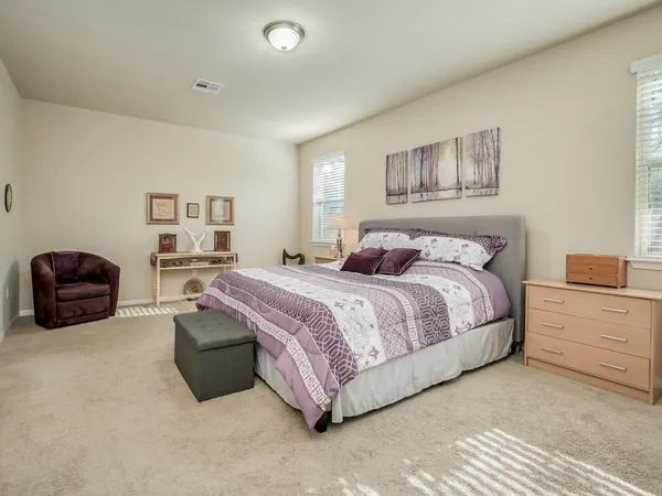 a bedroom with a bed and a large window