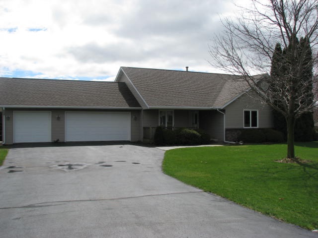9591 Rambouillet Ridge Roscoe, IL 61073 - Photo 1 of 19 a front view of a house with a garden