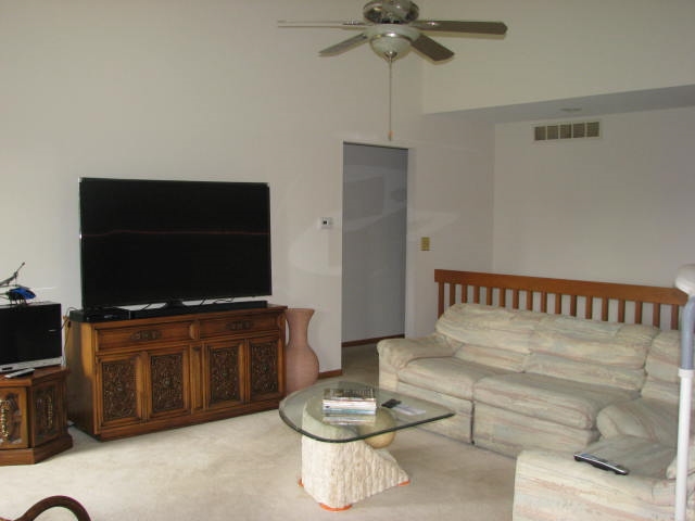 9591 Rambouillet Ridge Roscoe, IL 61073 - Photo 3 of 19 a living room with furniture and a flat screen tv