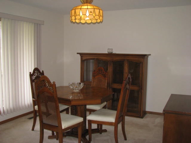 9591 Rambouillet Ridge Roscoe, IL 61073 - Photo 4 of 19 a view of a dining room with furniture and a window