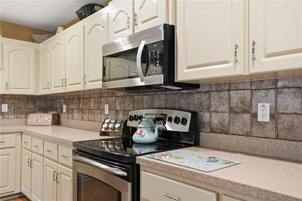 a kitchen with a sink stove and cabinets