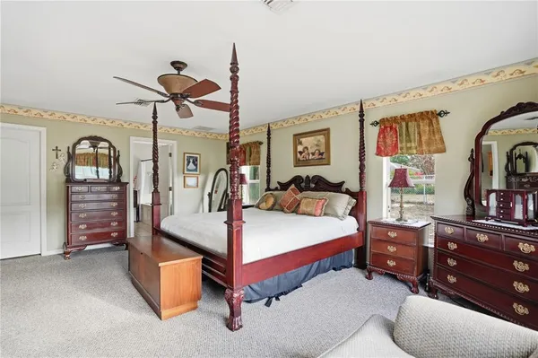 a bed room with a bed and a mirror