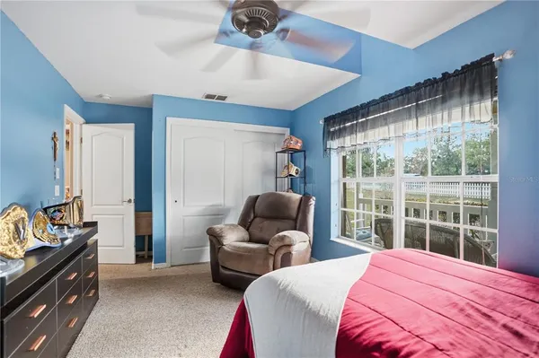 a bedroom with a bed and a couch