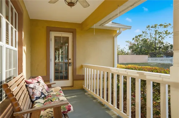a view of a porch with furniture and a yard