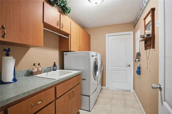 a utility room with refrigerator and washer