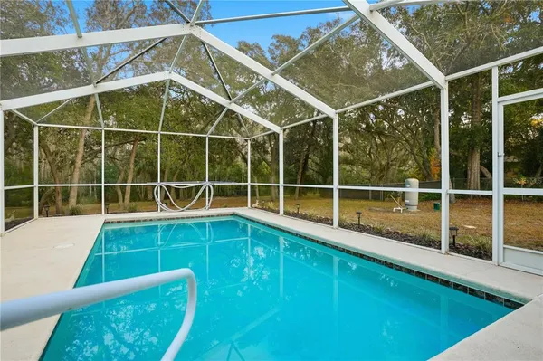 a view of a white building with a swimming pool
