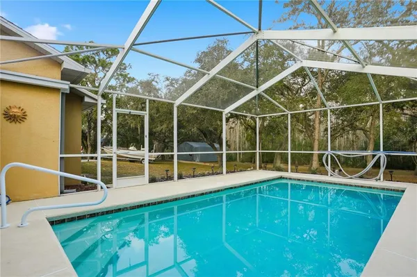 a view of a backyard with table and chairs