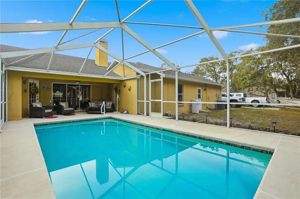a view of a backyard with table and chairs under an umbrella