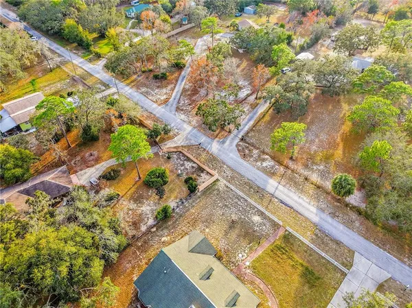 an aerial view of residential house with green space