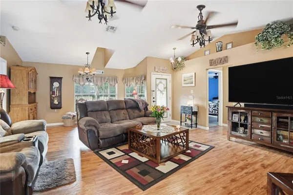 a living room with furniture and a flat screen tv