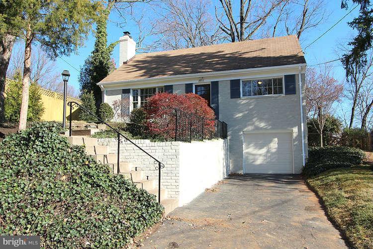 8817 Walnut Hill Road Chevy Chase, MD 20815 - Photo 1 of 26 a front view of house with a garden