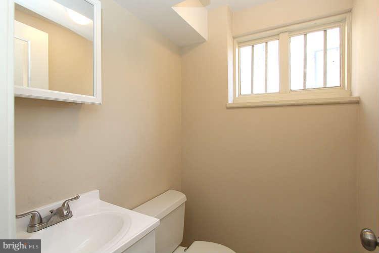 8817 Walnut Hill Road Chevy Chase, MD 20815 - Photo 22 of 26 a bathroom with a sink a toilet and a window