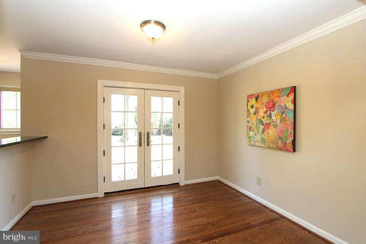 8817 Walnut Hill Road Chevy Chase, MD 20815 - Photo 5 of 26 a view of an empty room with wooden floor and a window