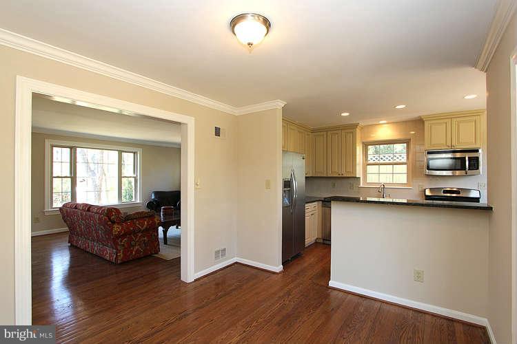 8817 Walnut Hill Road Chevy Chase, MD 20815 - Photo 7 of 26 a living room with furniture and a flat screen tv