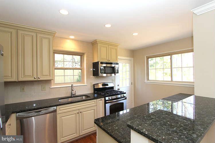 8817 Walnut Hill Road Chevy Chase, MD 20815 - Photo 8 of 26 a kitchen with granite countertop stainless steel appliances a stove sink and microwave