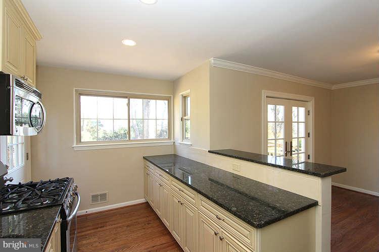 8817 Walnut Hill Road Chevy Chase, MD 20815 - Photo 9 of 26 a kitchen with granite countertop a stove and a sink