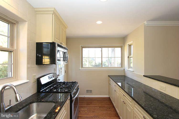 8817 Walnut Hill Road Chevy Chase, MD 20815 - Photo 10 of 26 a kitchen with granite countertop a stove and a sink