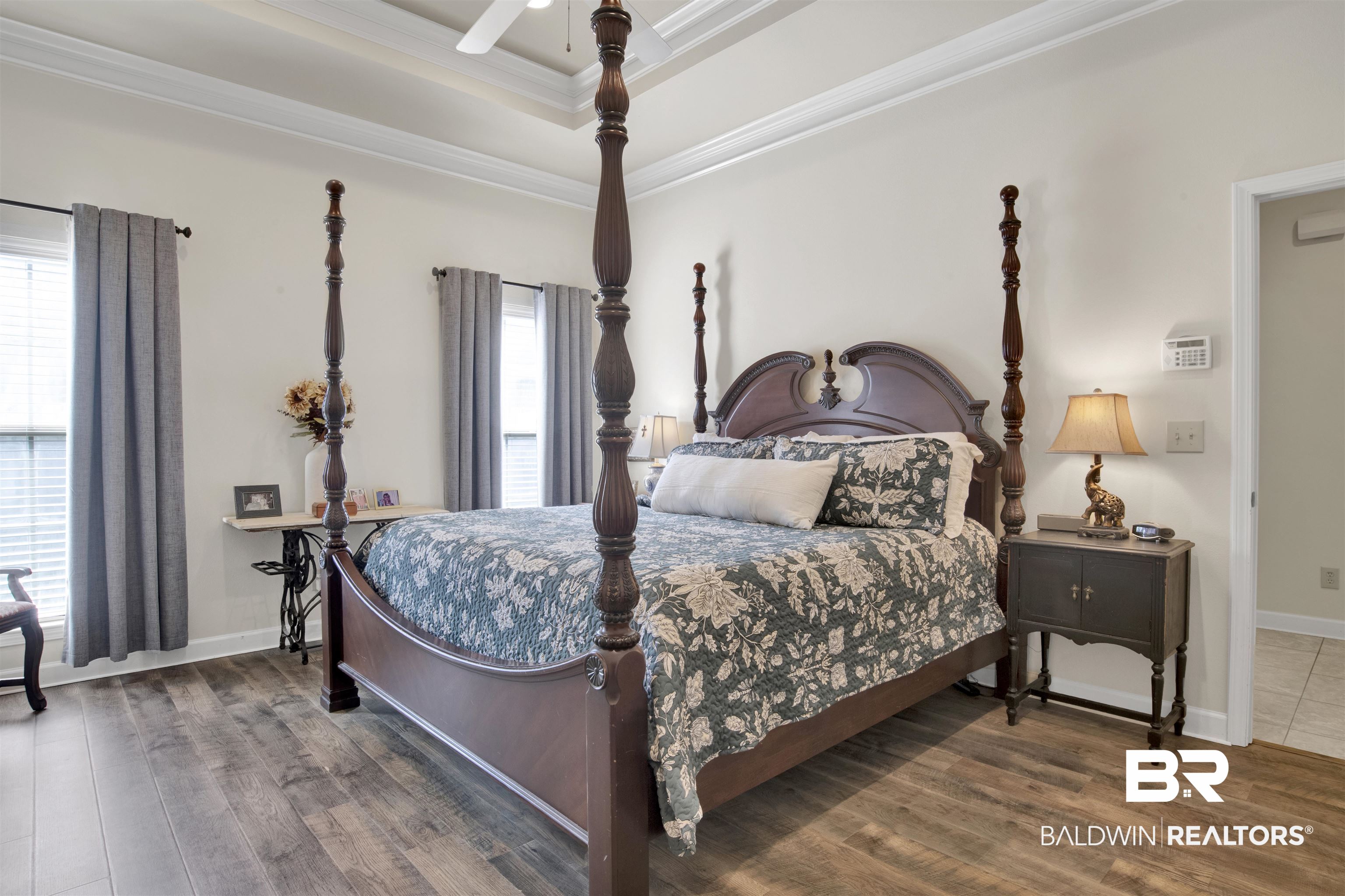 10368 Gayfer Rd Extension Fairhope, AL 36532 - Photo 19 of 43 Spacious room featuring wood-finish flooring, a tray ceiling with a ceiling fan, and two windows with blinds and drapery
