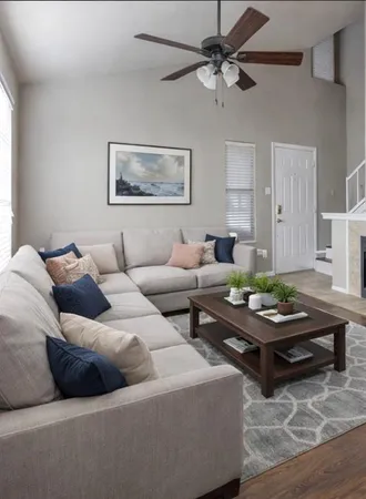 a view of an empty room with wooden floor fireplace and a window