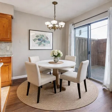 an empty room with wooden floor closet and fan