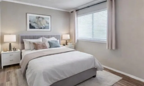 a bathroom with a granite countertop bathtub shower sink mirror vanity and toilet