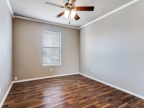 a view of parking space and a car parked in front of a house
