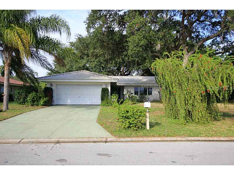 1852 Riviera Circle Sarasota, FL 34232 - Photo 1 of 1 a front view of a house with a yard