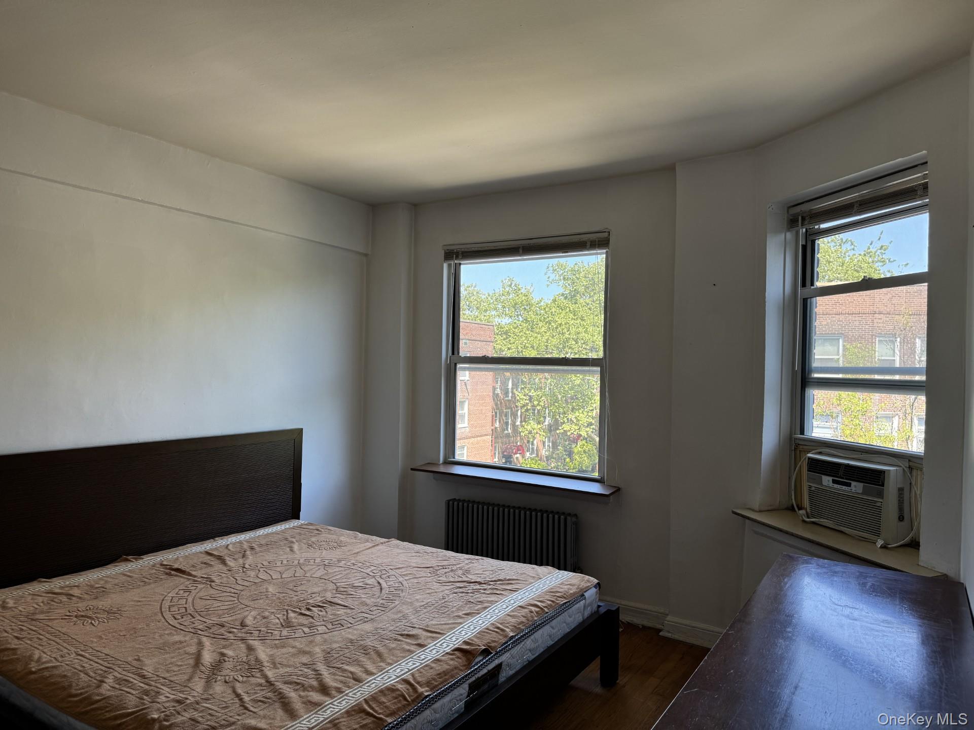 141-24 78th Road, Unit 3A Queens, NY 11367 - Photo 7 of 18 a bedroom with a bed and a window