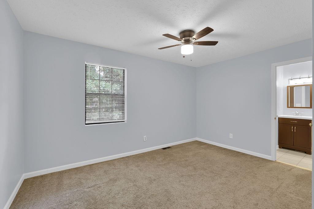 1424 Springleaf Circle Southeast Smyrna, GA 30080 - Photo 30 of 38 an empty room with windows and fan