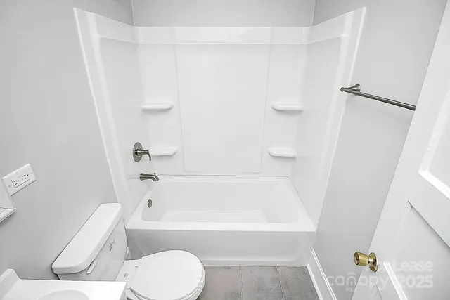 a bathroom with a bathtub and a toilet