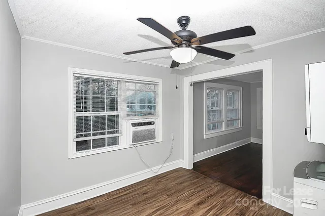 a view of a livingroom with a ceiling fan and wooden floor