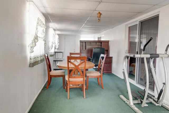 a dining room with furniture and a window