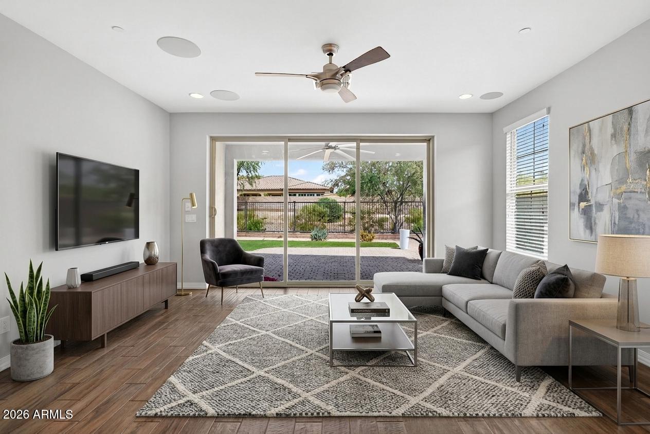 12124 West Peak View Road Peoria, AZ 85383 - Photo 11 of 38 a living room with furniture a flat screen tv and a large window