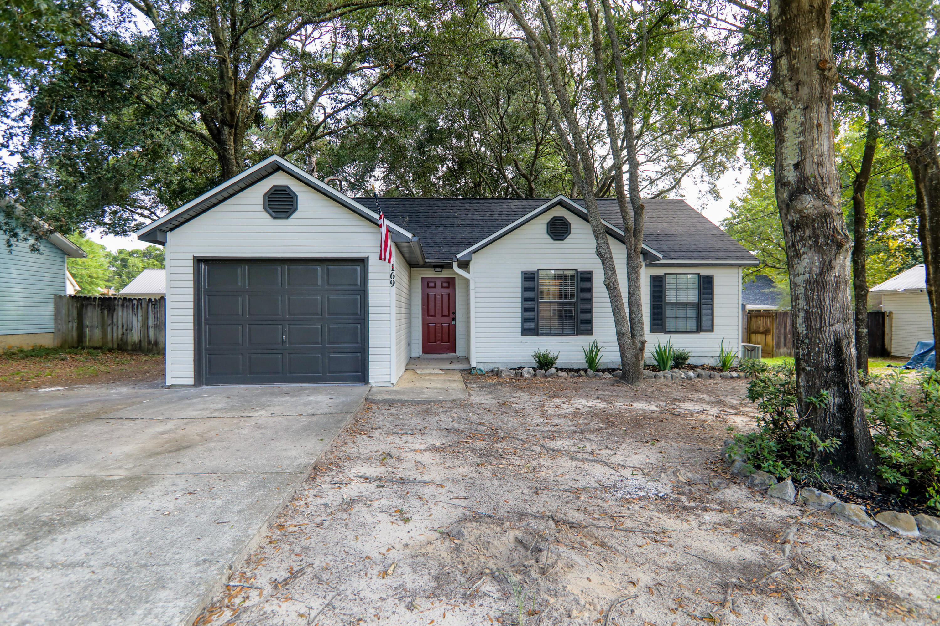 169 John King Road Crestview, FL 32539 - Photo 1 of 20 a front view of a house with a yard and garage