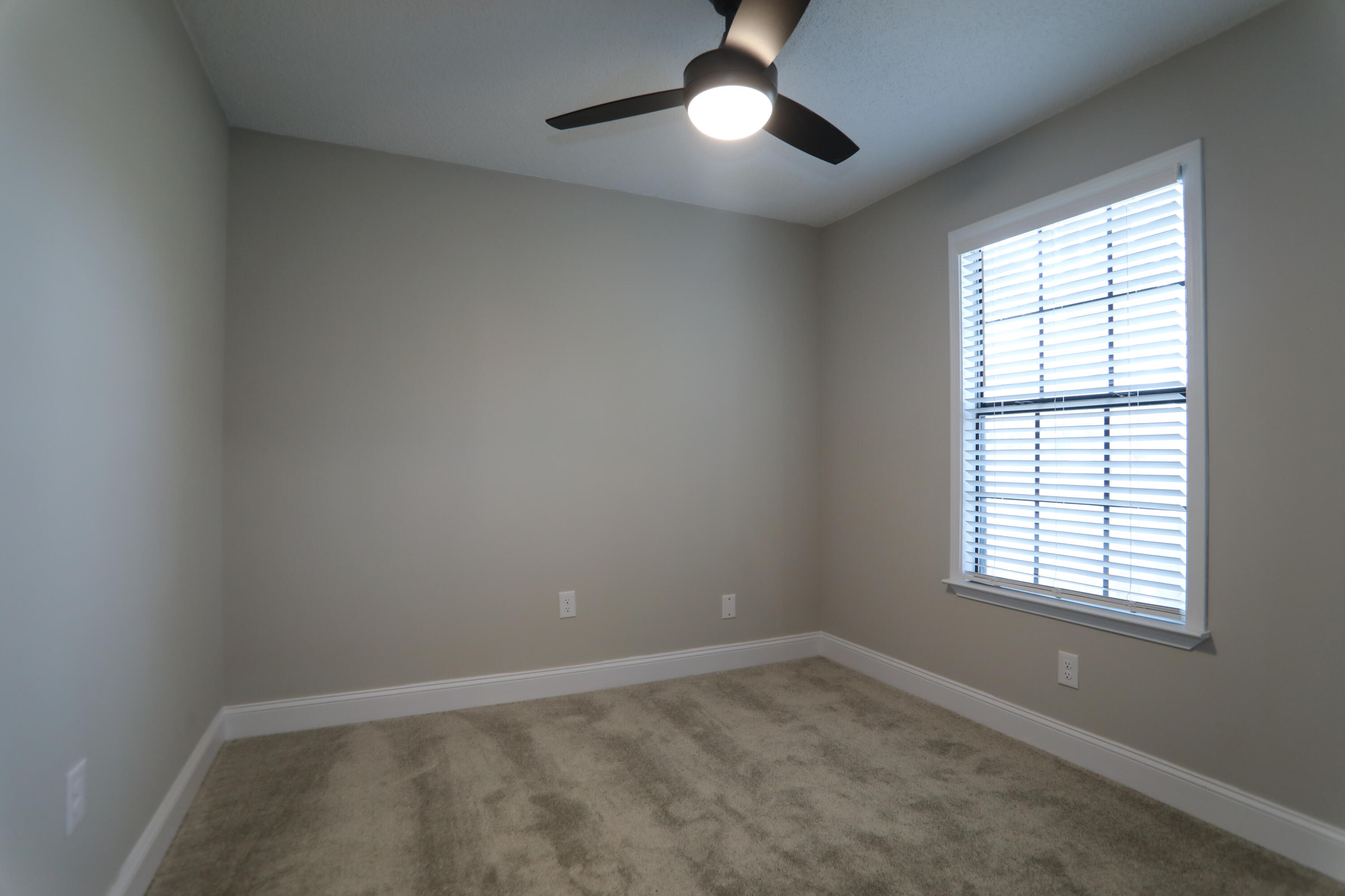 169 John King Road Crestview, FL 32539 - Photo 14 of 20 an empty room with a window and a fan