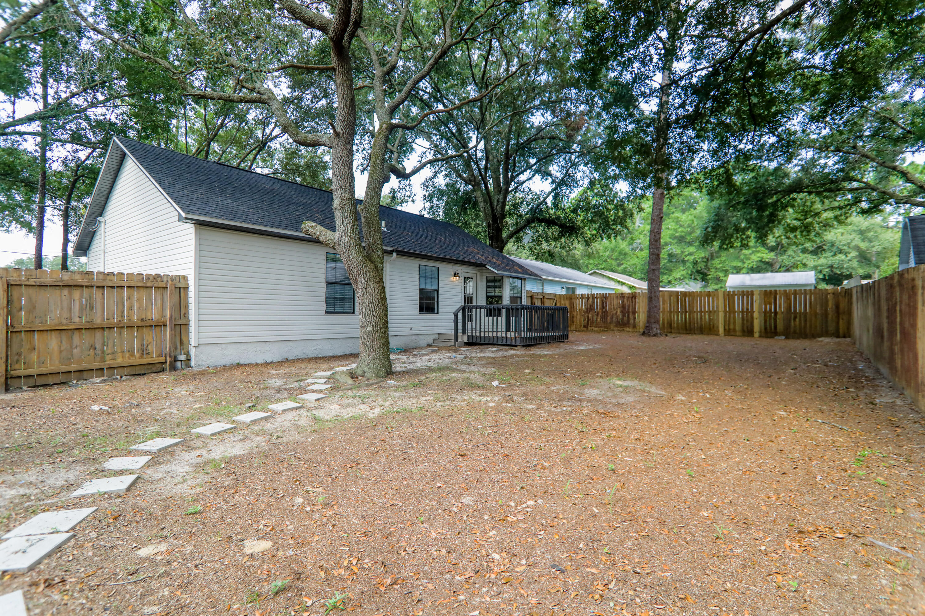 169 John King Road Crestview, FL 32539 - Photo 18 of 20 a view of a house with a backyard and a garage