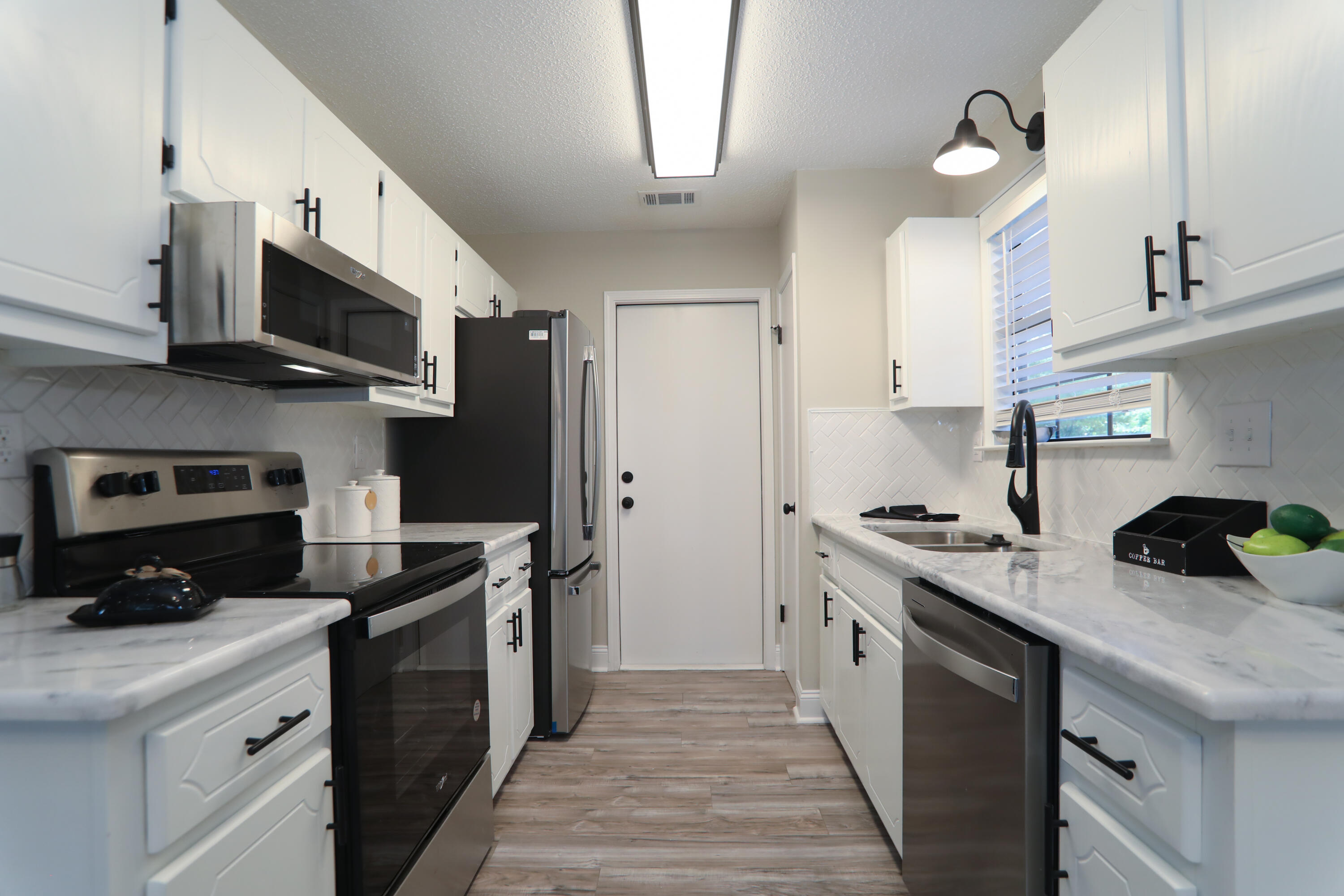 169 John King Road Crestview, FL 32539 - Photo 2 of 20 a kitchen with stainless steel appliances granite countertop a sink a stove and a refrigerator