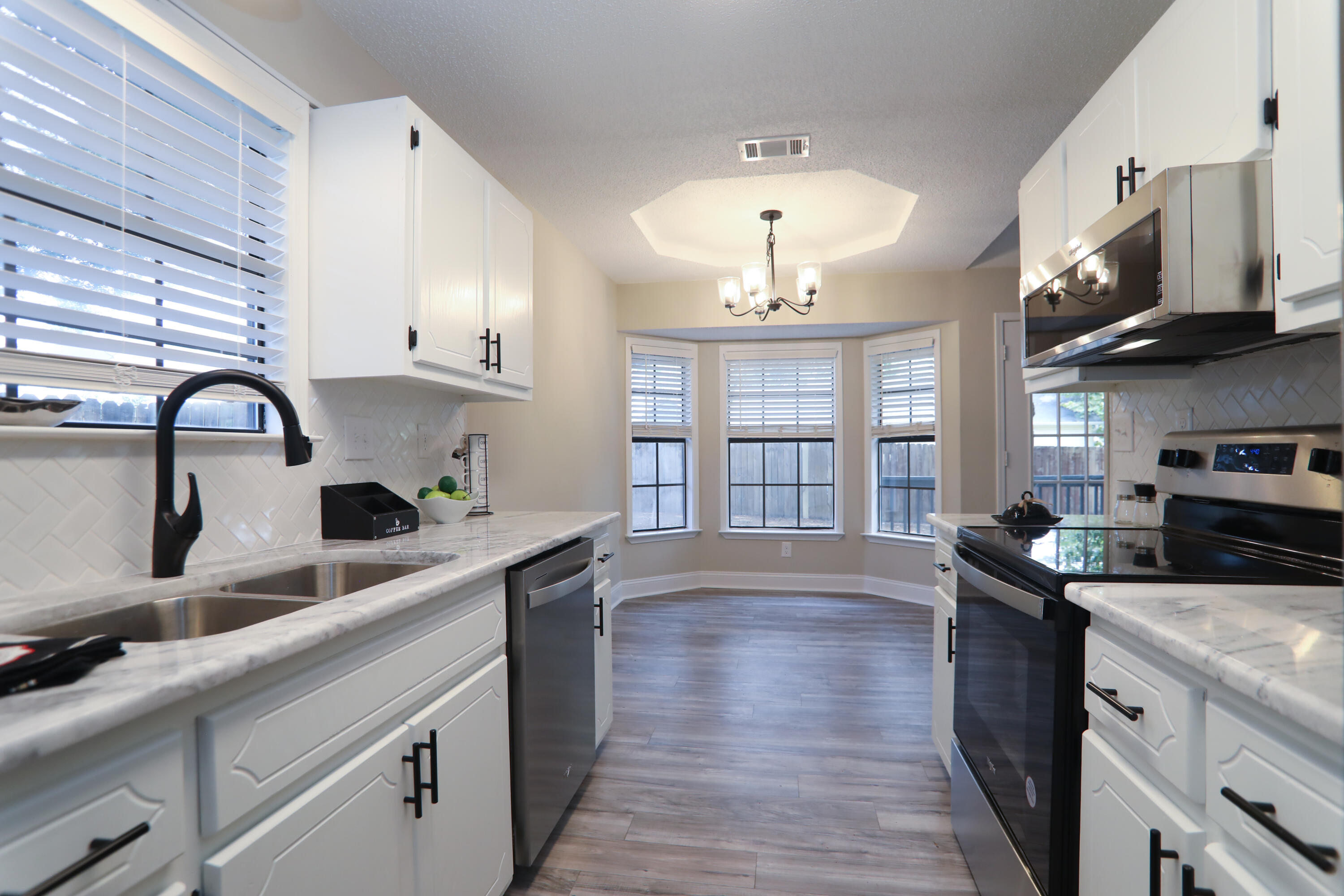 169 John King Road Crestview, FL 32539 - Photo 3 of 20 a kitchen with stainless steel appliances a sink a stove and cabinets