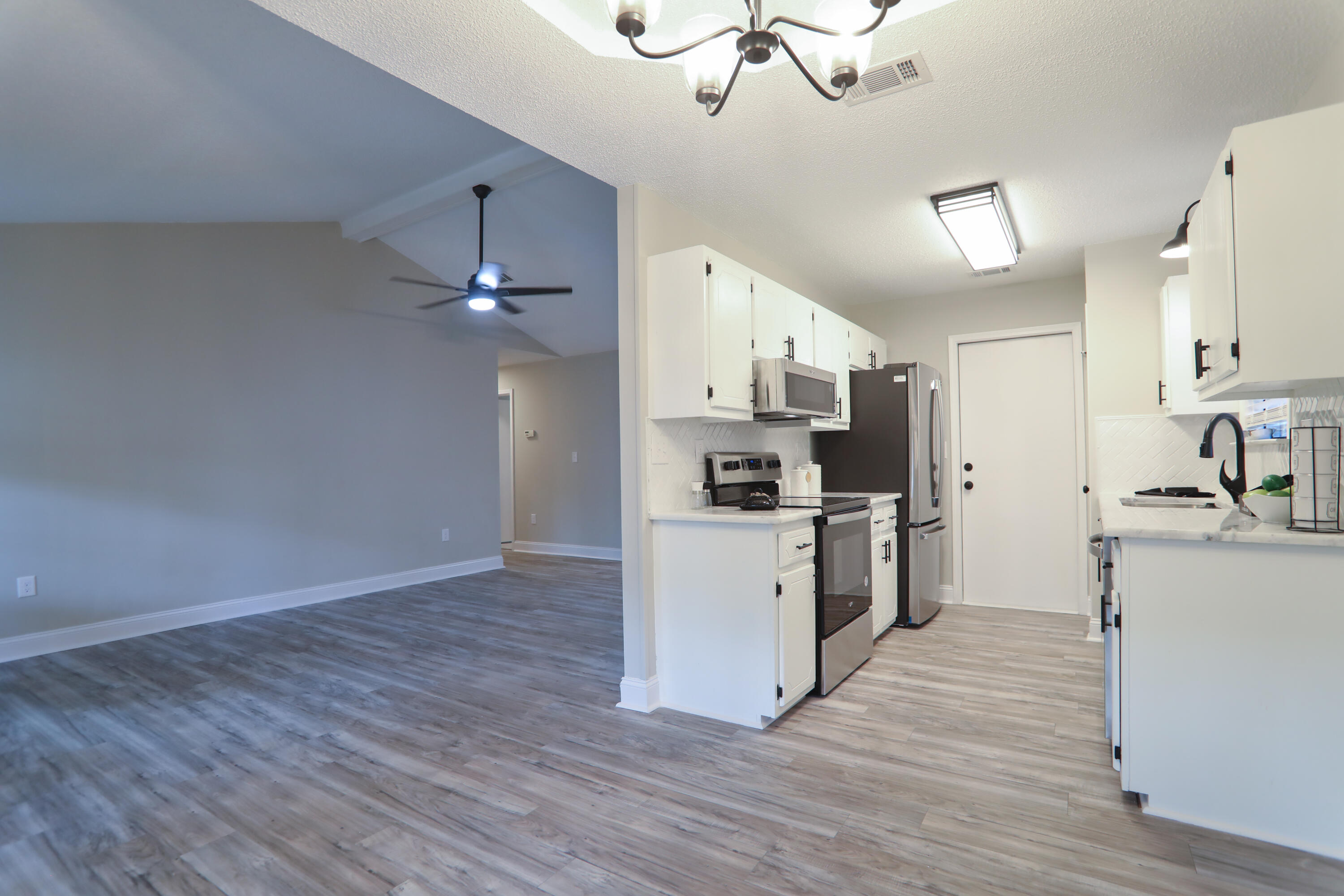 169 John King Road Crestview, FL 32539 - Photo 4 of 20 a kitchen with white cabinets and stainless steel appliances