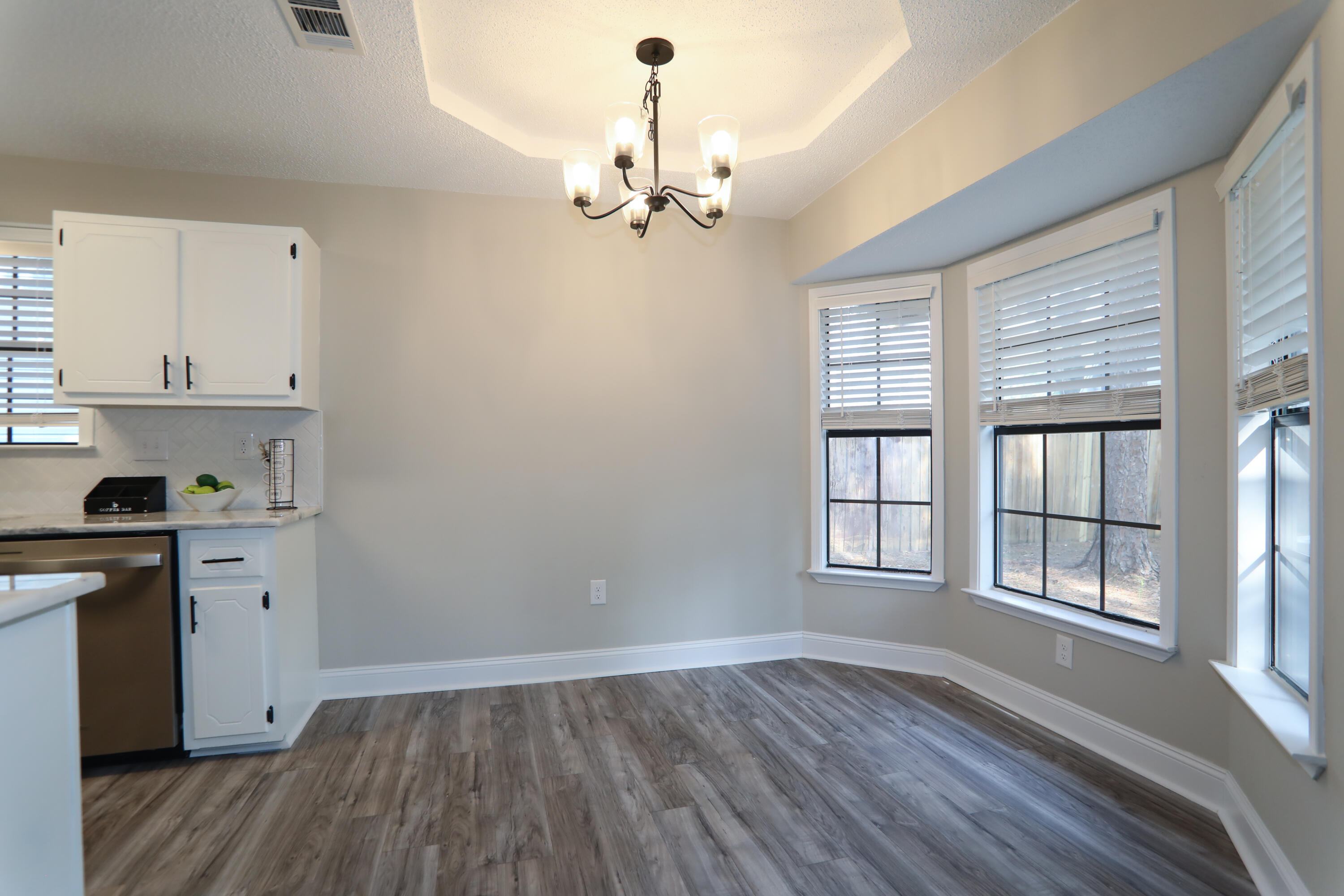 169 John King Road Crestview, FL 32539 - Photo 5 of 20 a view of a kitchen with dishwasher and wooden floor