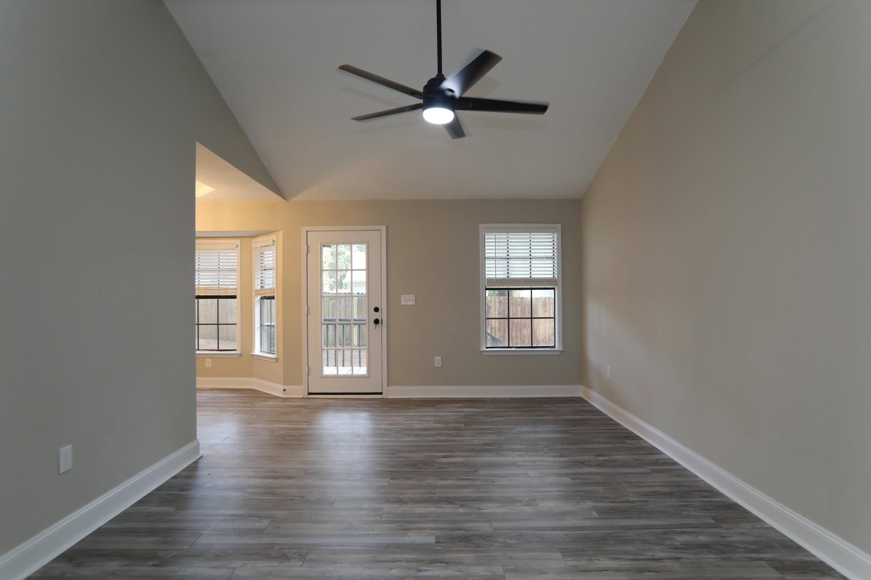 169 John King Road Crestview, FL 32539 - Photo 6 of 20 a view of an empty room with window and wooden floor