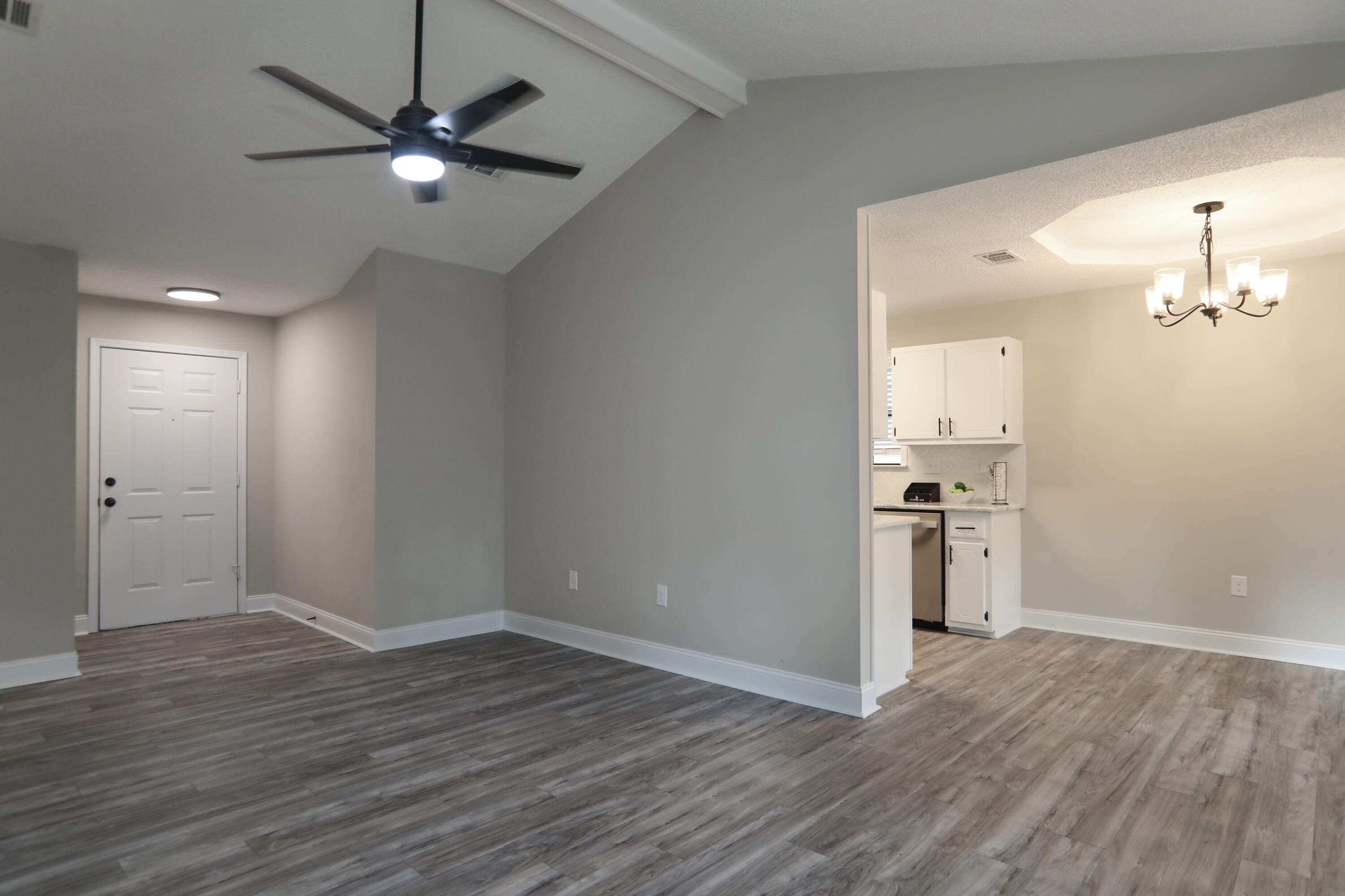 169 John King Road Crestview, FL 32539 - Photo 7 of 20 an empty room with wooden floor and a ceiling fan
