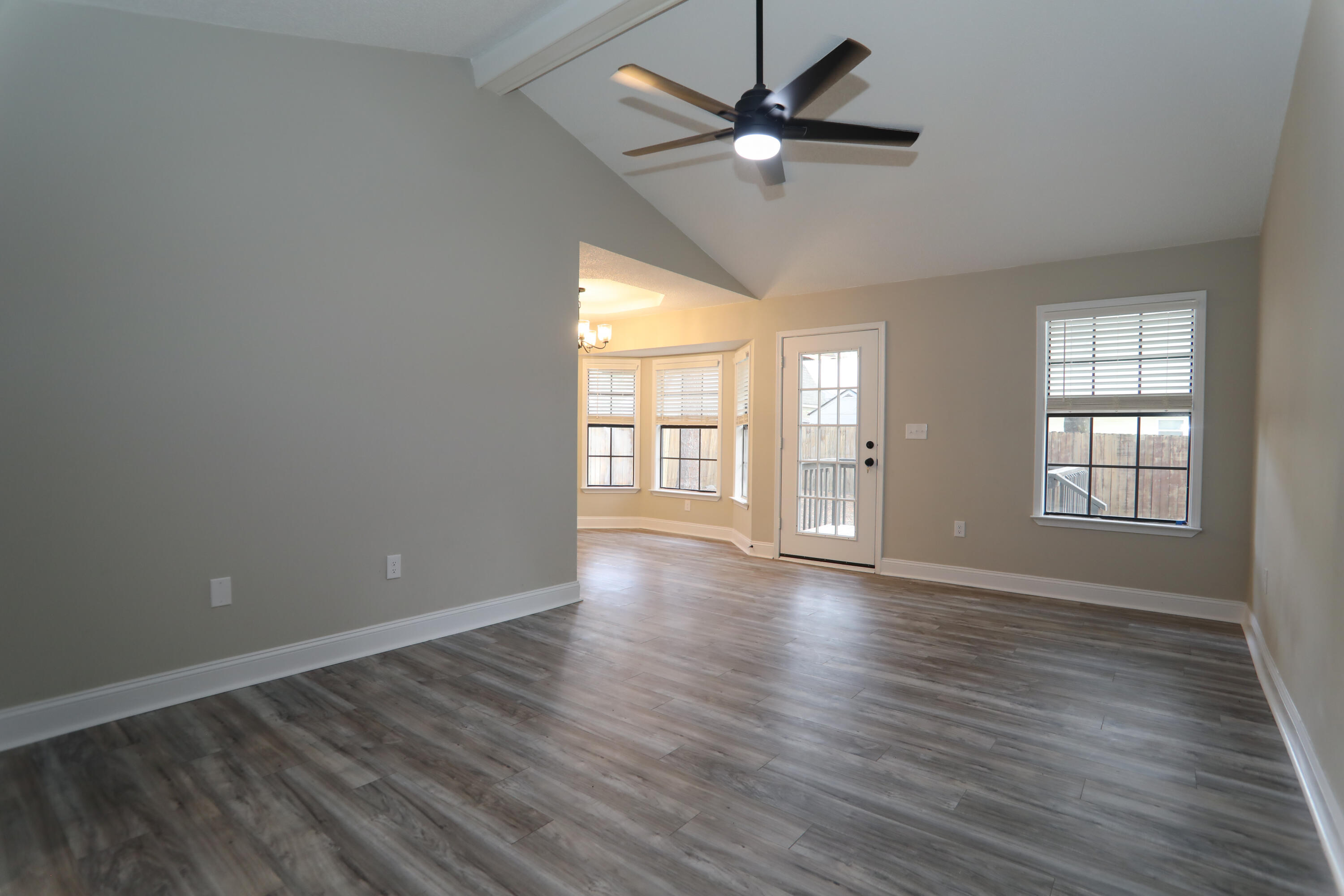 169 John King Road Crestview, FL 32539 - Photo 9 of 20 an empty room with wooden floor fan and windows