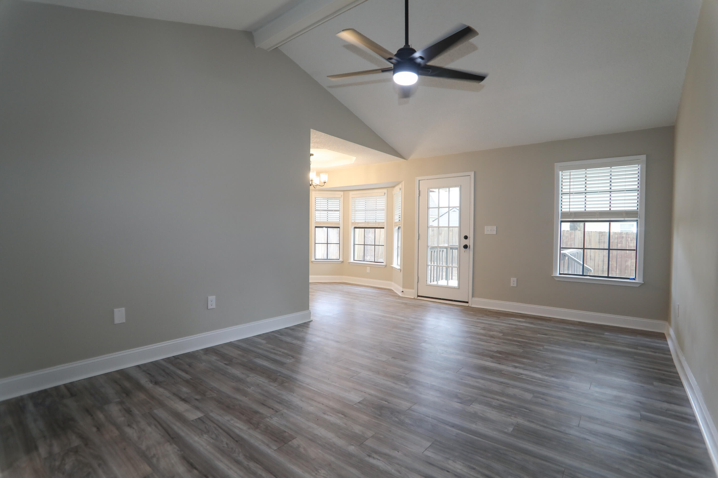 169 John King Road Crestview, FL 32539 - Photo 10 of 20 an empty room with wooden floor fan and windows