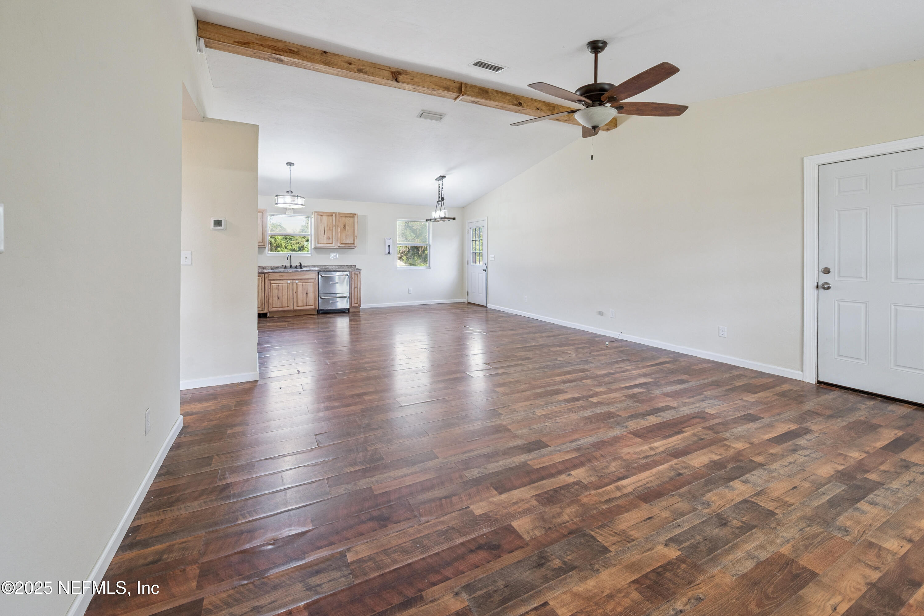 4881 Southwest 136th Court Lake Butler, FL 32054 - Photo 6 of 25 a view of a livingroom with a hardwood floor and a ceiling fan