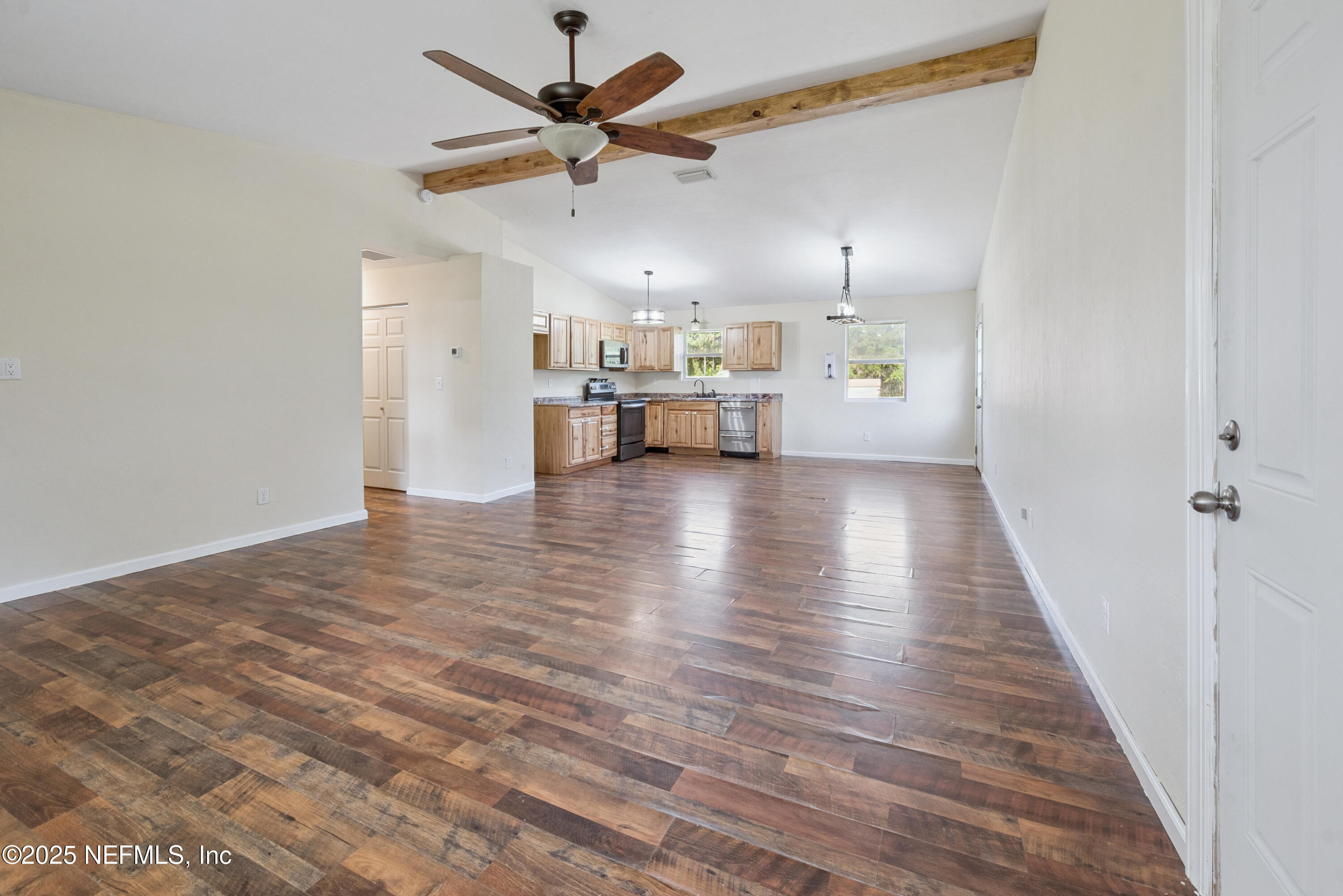 4881 Southwest 136th Court Lake Butler, FL 32054 - Photo 7 of 25 a view of a livingroom with wooden floor and a ceiling fan